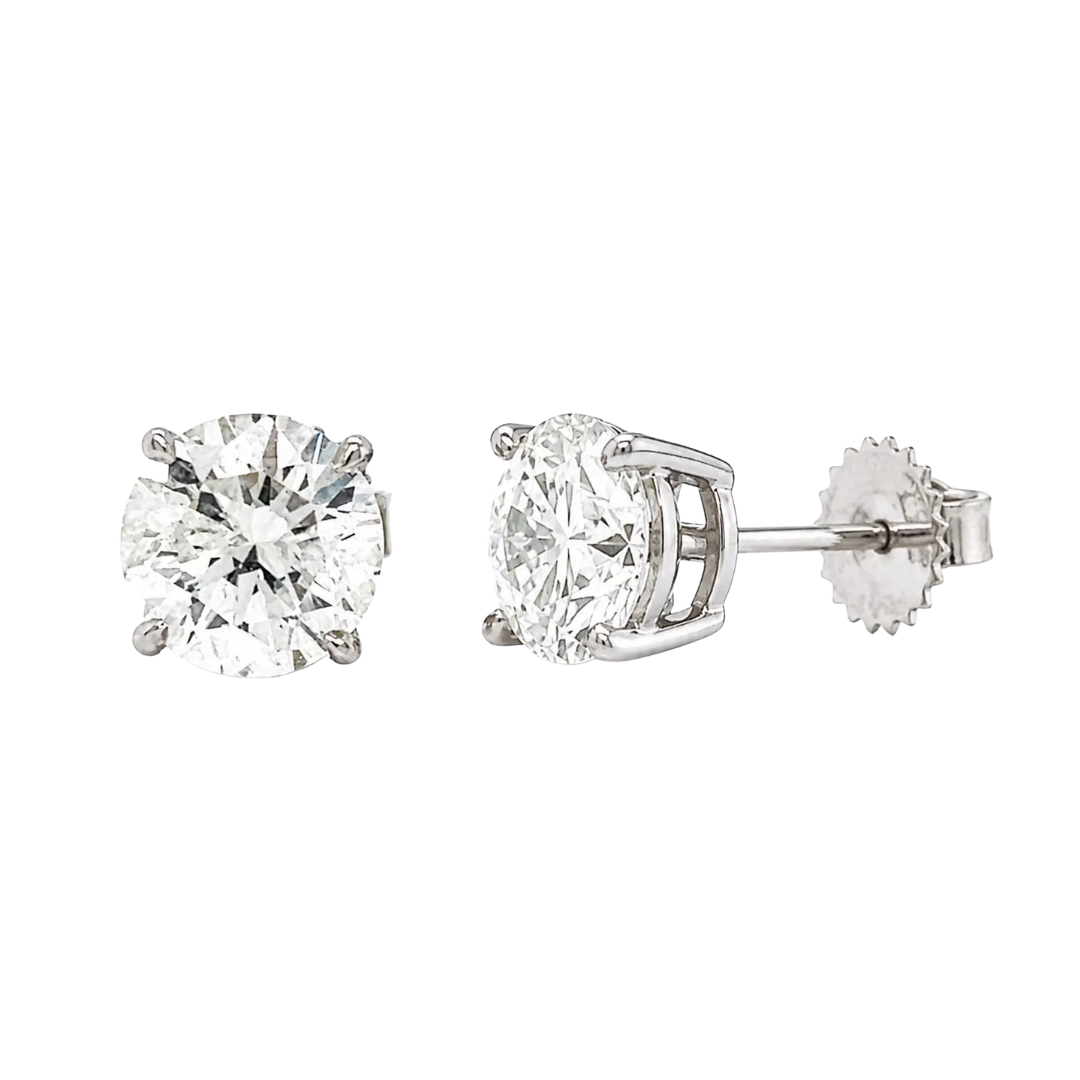 Pair of diamond stud earrings on a white background