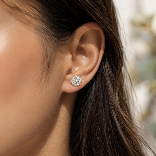 Close-up of an ear wearing a diamond earring with blurred background