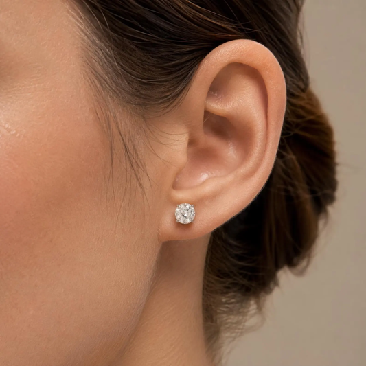 Close-up of an ear wearing a diamond earring with a blurred background