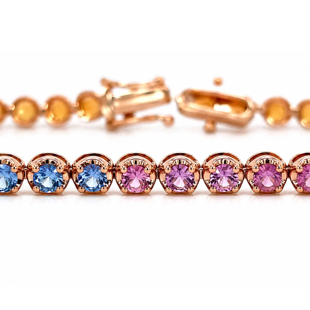 Bracelet with rose gold clasp and colorful gemstones on a white background