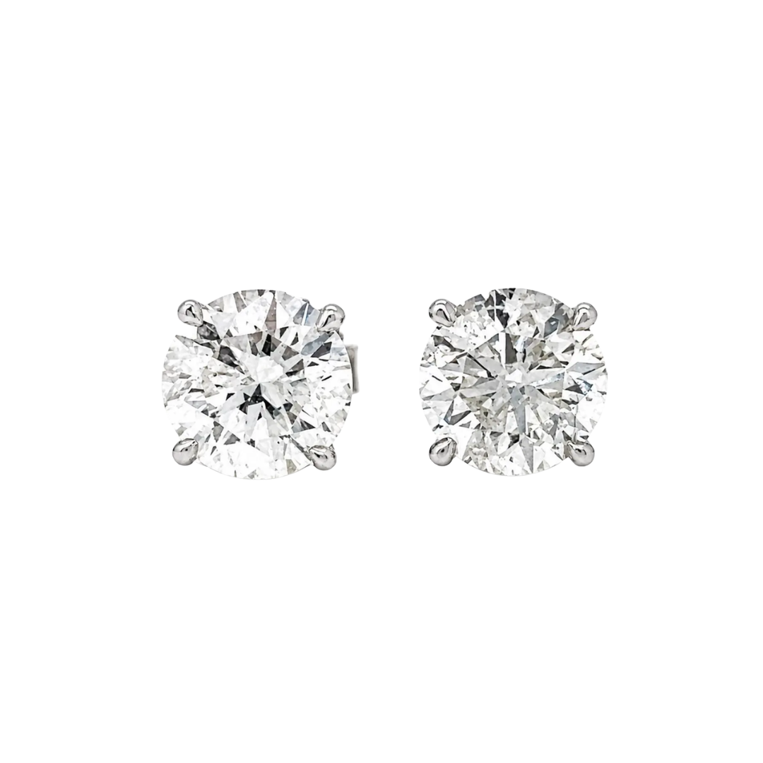 Pair of diamond stud earrings on a white background