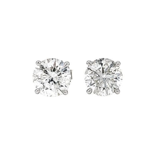 Pair of diamond stud earrings on a white background