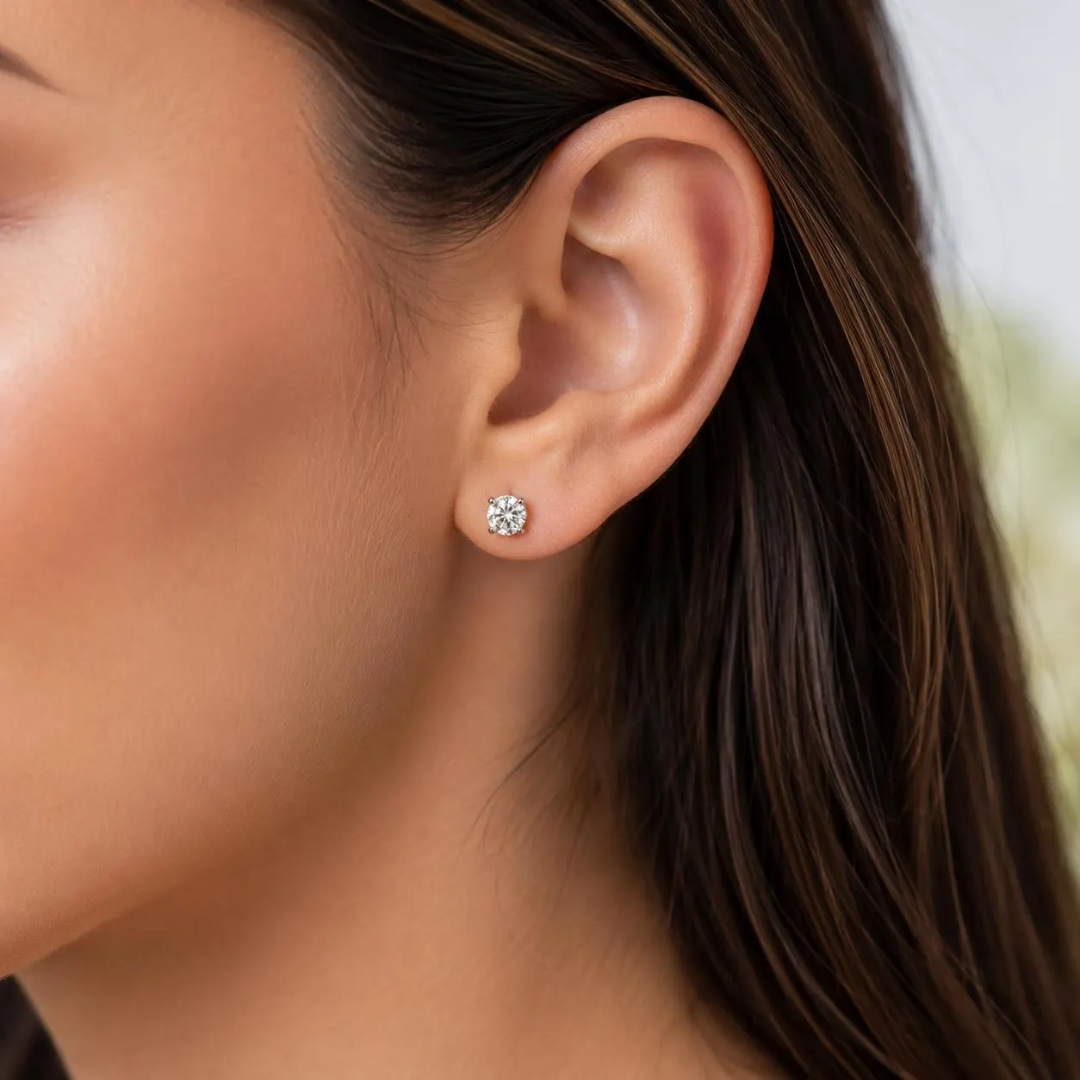 Close-up of a woman wearing a diamond earring.