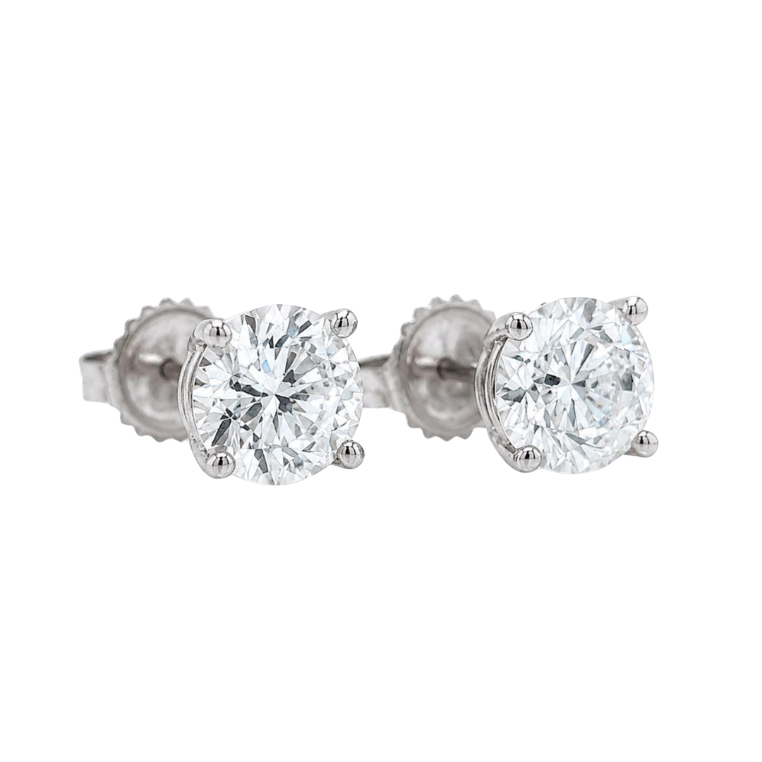 Pair of diamond stud earrings on a white background side
