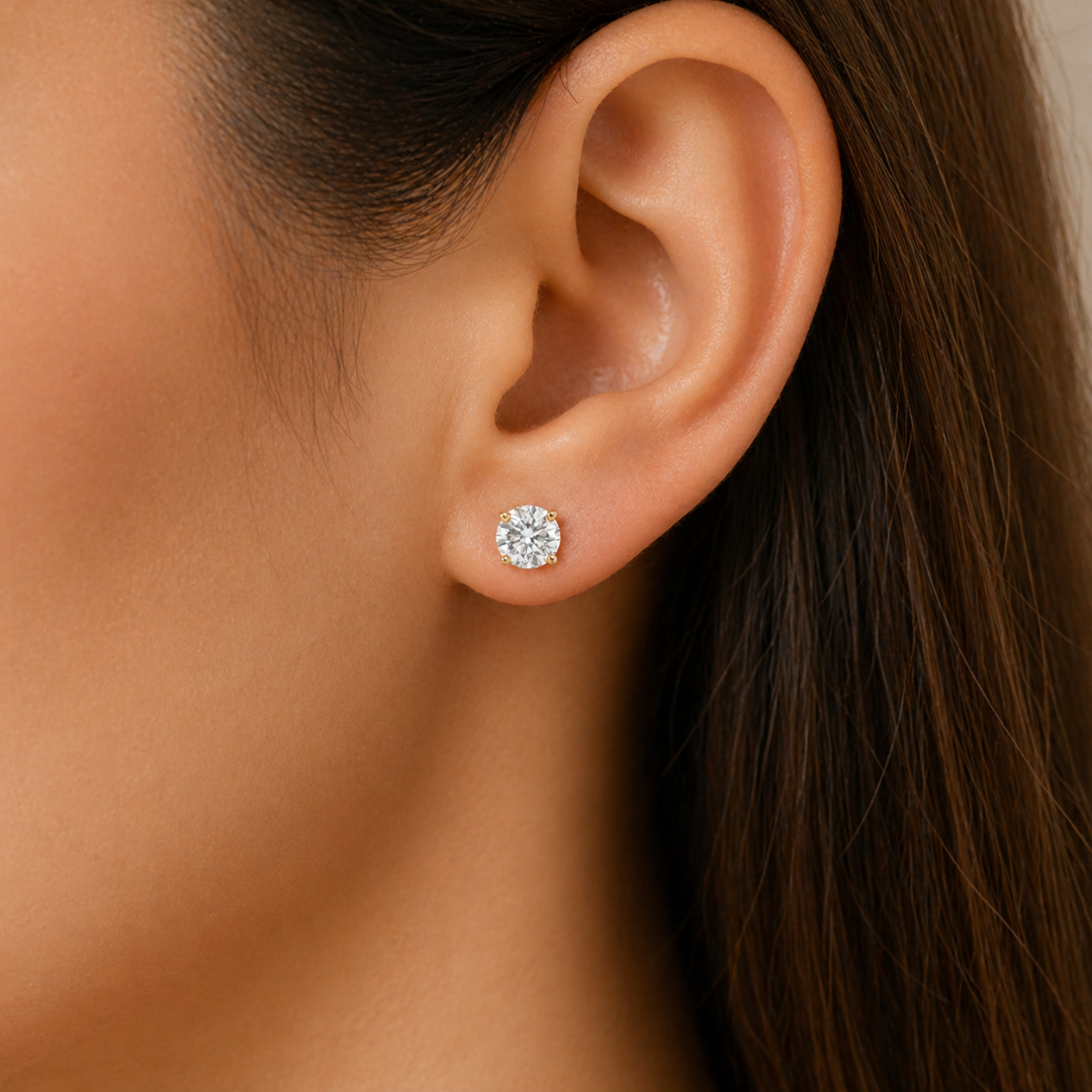 Close-up of an ear wearing a diamond earring with blurred background