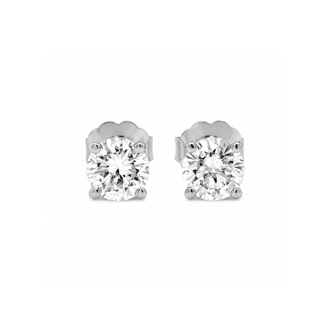 Pair of diamond stud earrings on a white background