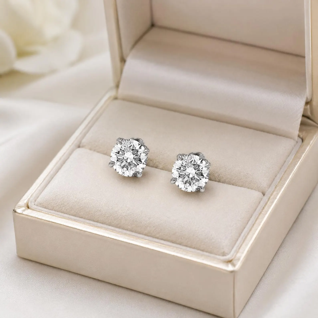 Diamond earrings in a jewelry box on a light background