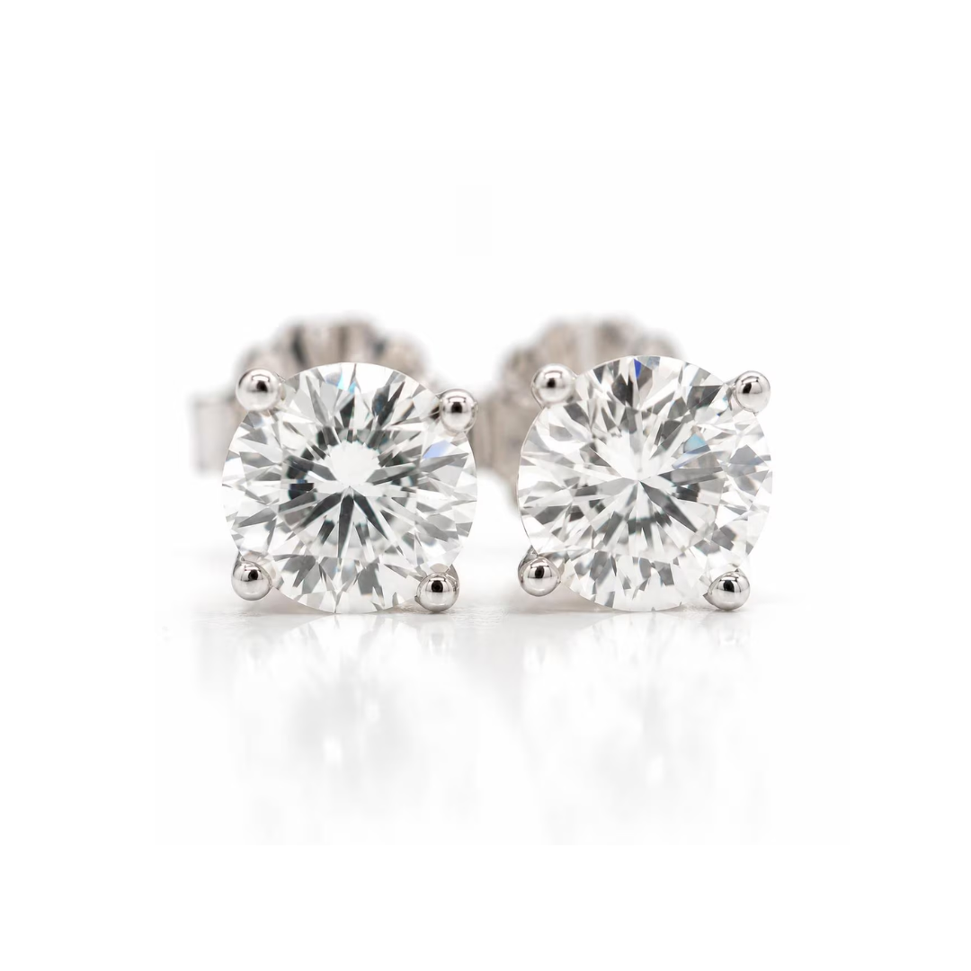 Pair of diamond stud earrings on a white background