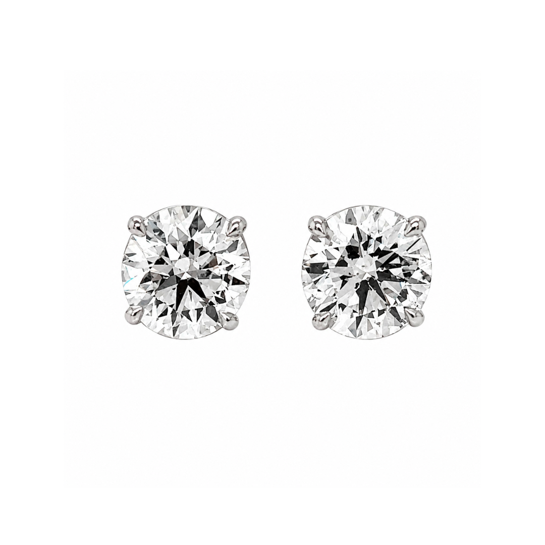 Pair of diamond stud earrings on a white background