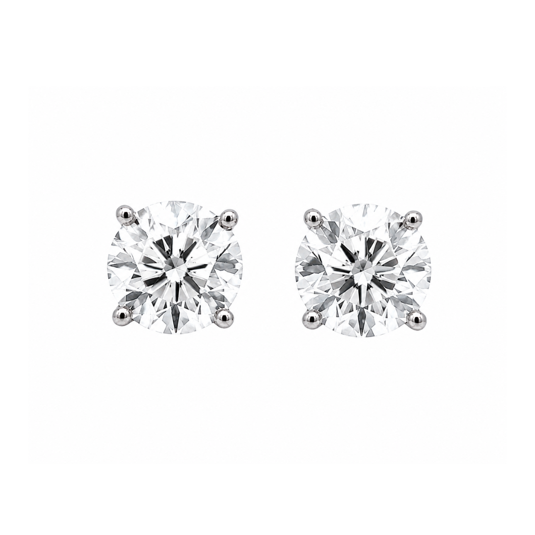Pair of diamond stud earrings on a white background
