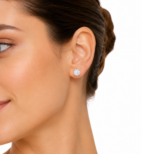 Close-up of a woman wearing a diamond earring on a white background
