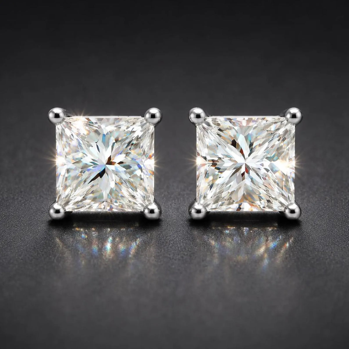 Pair of diamond stud earrings on a dark background